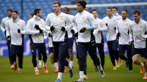 Manchester City's players warm up during a training session at the Etihad Stadium in Manchester
